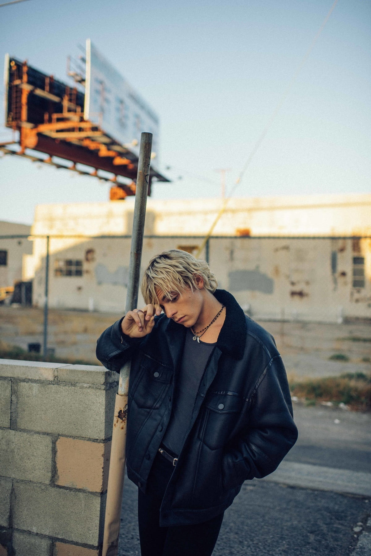 Black leather jacket by Alexander Wang, tank top by Calvin Klein, jeans by Agolde, belt by Palace Costume. Actor: Ross Lynch. Stylist: Sean Knight. Hair Stylist: Lucy Halperin