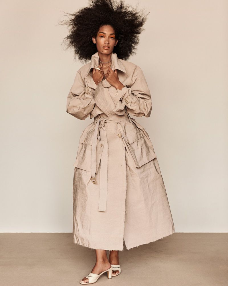 Clothing: trench coat by Eckhaus Latta, mules by Maryam Nassir Zadeh, gold necklace and ring by Sherman Field, gold ring by Prounis, ear cuff by Charlotte Chesnais. 