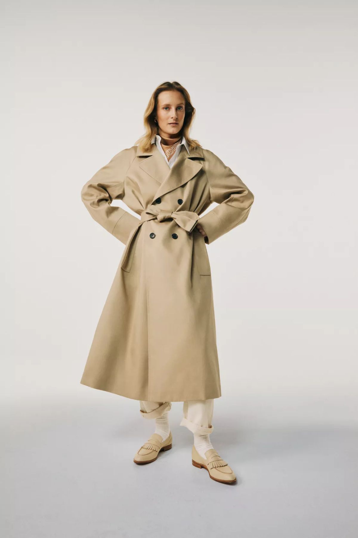 Olympia Campbell wears Connolly Beige Trench Coat, WARDROBE.NYC White Shirt, Raey Off-White Jeans, Crockett & Jones Shoes Wardrobe Foundations Matches Fashion