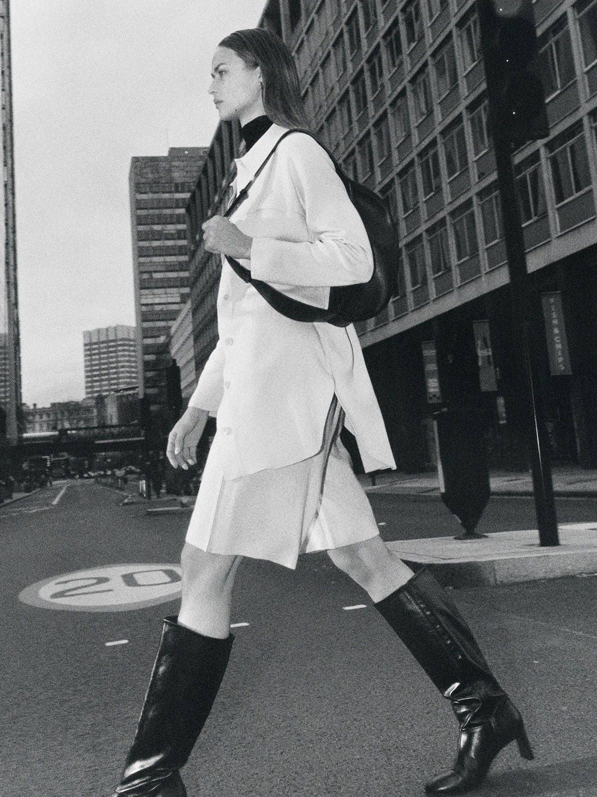 COS Black KNEE HIGH HEELED LEATHER BOOTS / COS Beige KNITTED TUNIC SHIRT / COS Off-White WIDE-LEG KNITTED SHORTS / COS Black RIBBED MOCK NECK TOP. Model: Birgit Kos. Photographer: Daniel Shea. Stylist: Clare Richardson. Hair Stylist: Yumi Nakada-Dingle. Makeup Artist: Niamh Quinn. Art Director: Andy Knappett