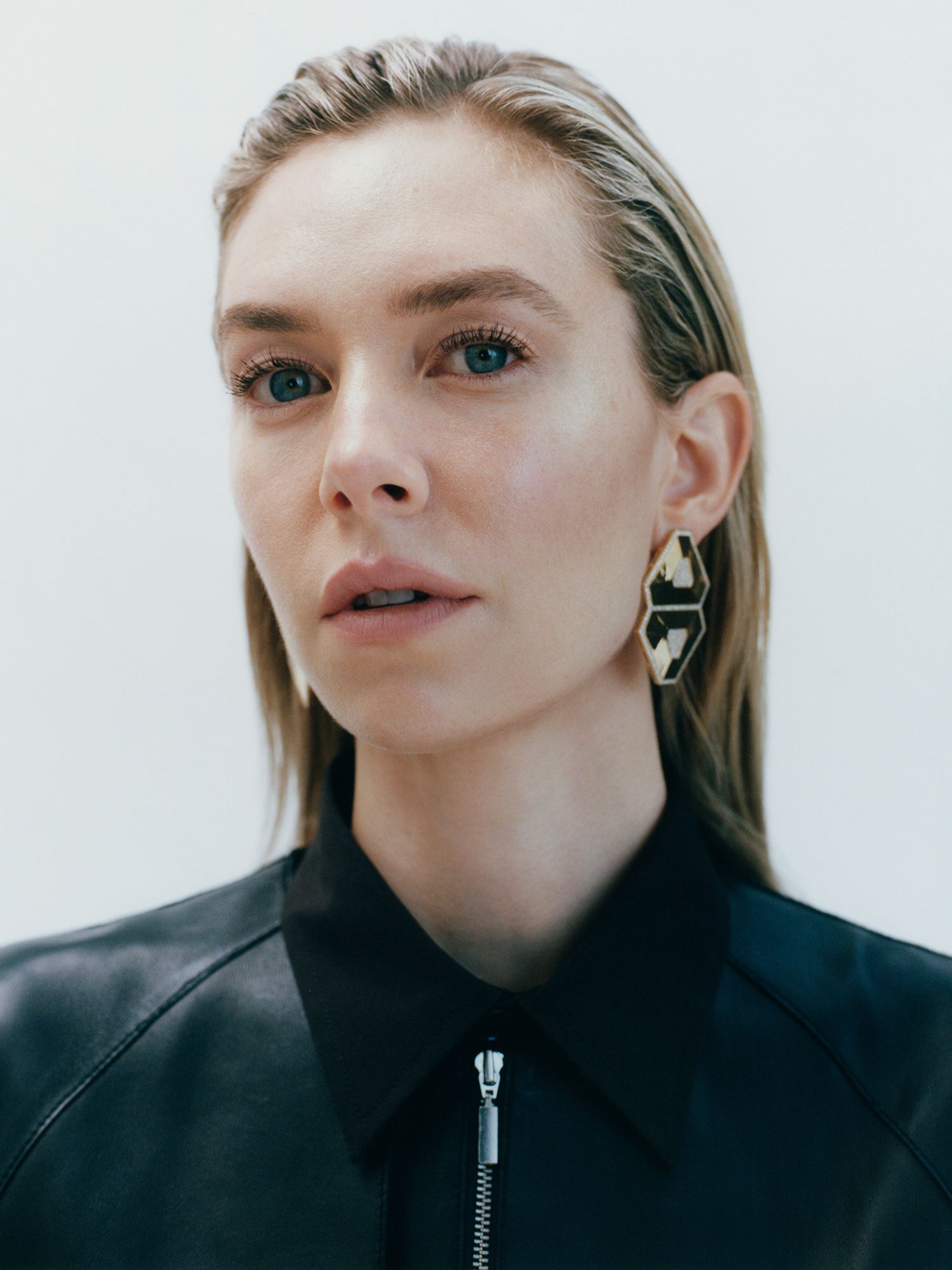 Center Stage: Vanessa Kirby by Toby Coulson for Porter Magazine April 2021. Clothing & Accessories: Leather coat, Toteme; shirt, Bottega Veneta; earrings, Ofira