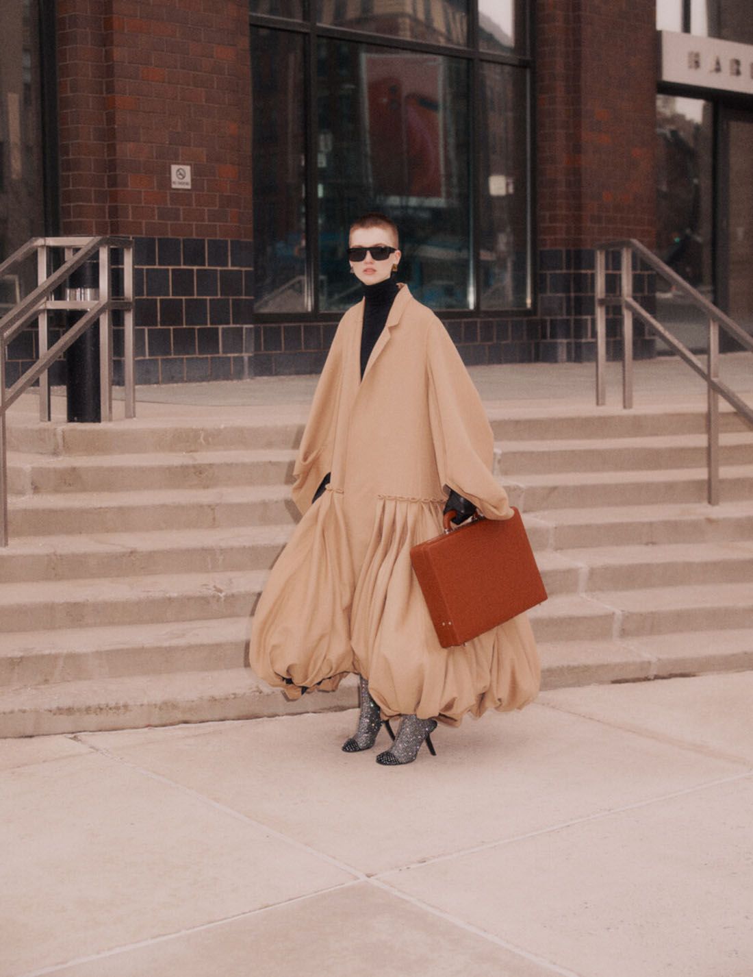 Clothing & Accessories: Dress by Loewe; Boots, Earrings by Balenciaga; Sunglasses by MYKITA Uptown Girl: Ruth Bell by Nagi Sakai for Vogue Ukraine April 2021