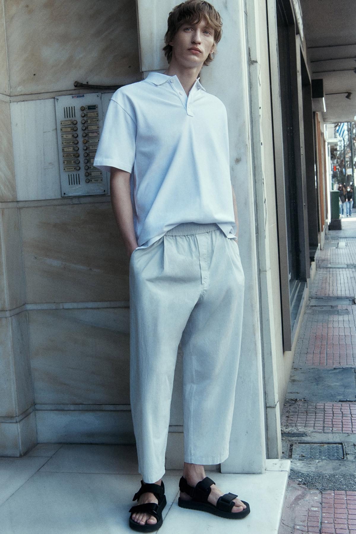Core by COS Men Summer 2021 Ad Campaign by Robin Galiegue. Clothing & Accessories: COS WHITE POLO SHIRT / COS MOLE GREY ELASTICATED TAPERED PANTS / COS BLACK STRAP SANDALS