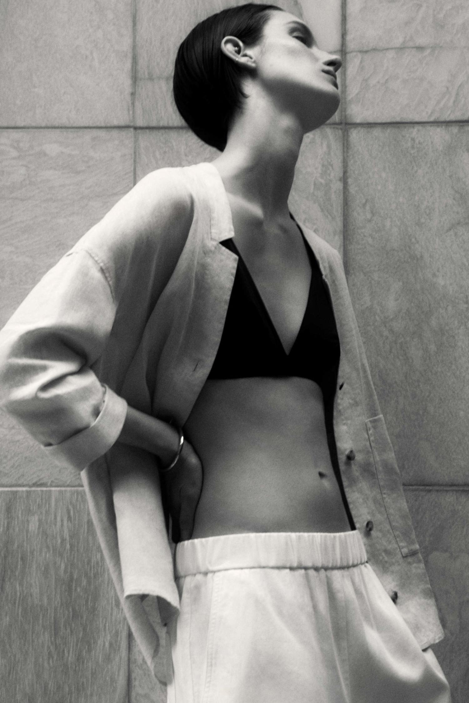 Clothing & Accessories: COS LILAC LINEN OPEN COLLAR SHIRT / COS BLACK TRIANGLE BIKINI TOP / COS WHITE COTTON-LINEN SHORTS Marte Mei van Haaster by Robin Galiegue for Core by COS Summer 2021 Ad Campaign