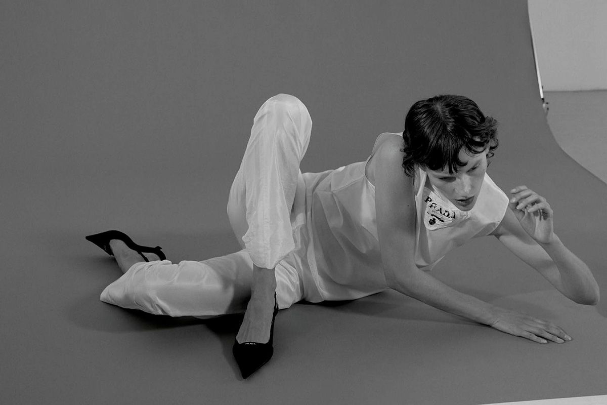Clothing & Accessories: Top, pants by Prada / Prada triangle patch slingback pumps / Model: Sara Blomqvist. Stylist: Maximilian Aufschnaiter. Beauty Artist: Lydia Bredl