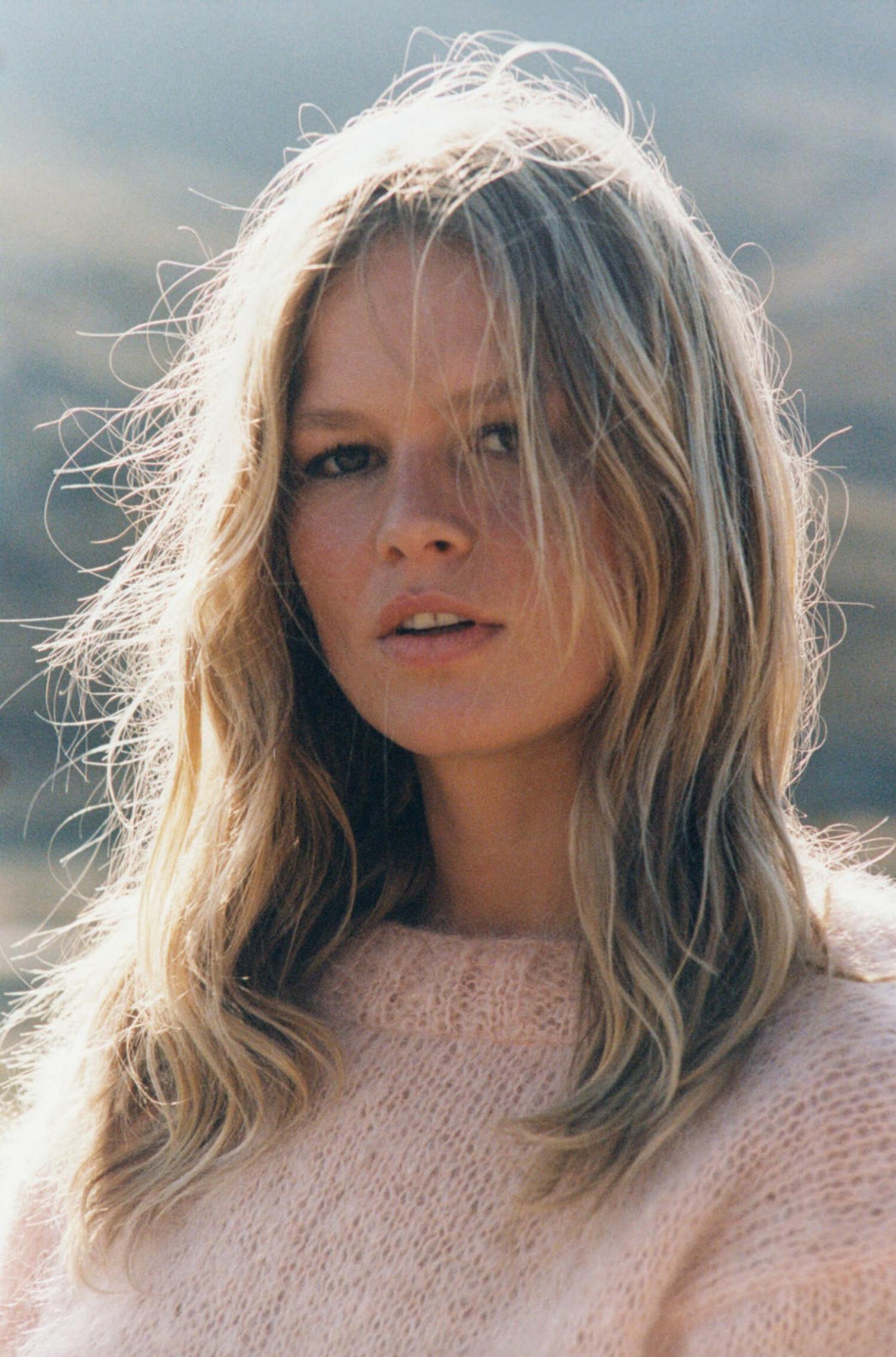 Anna Ewers in Mykonos by Henrik Purienne for Vogue Paris August 2021. Clothing: Sweater by Rose Carmine; Makeup using Dior Beauty