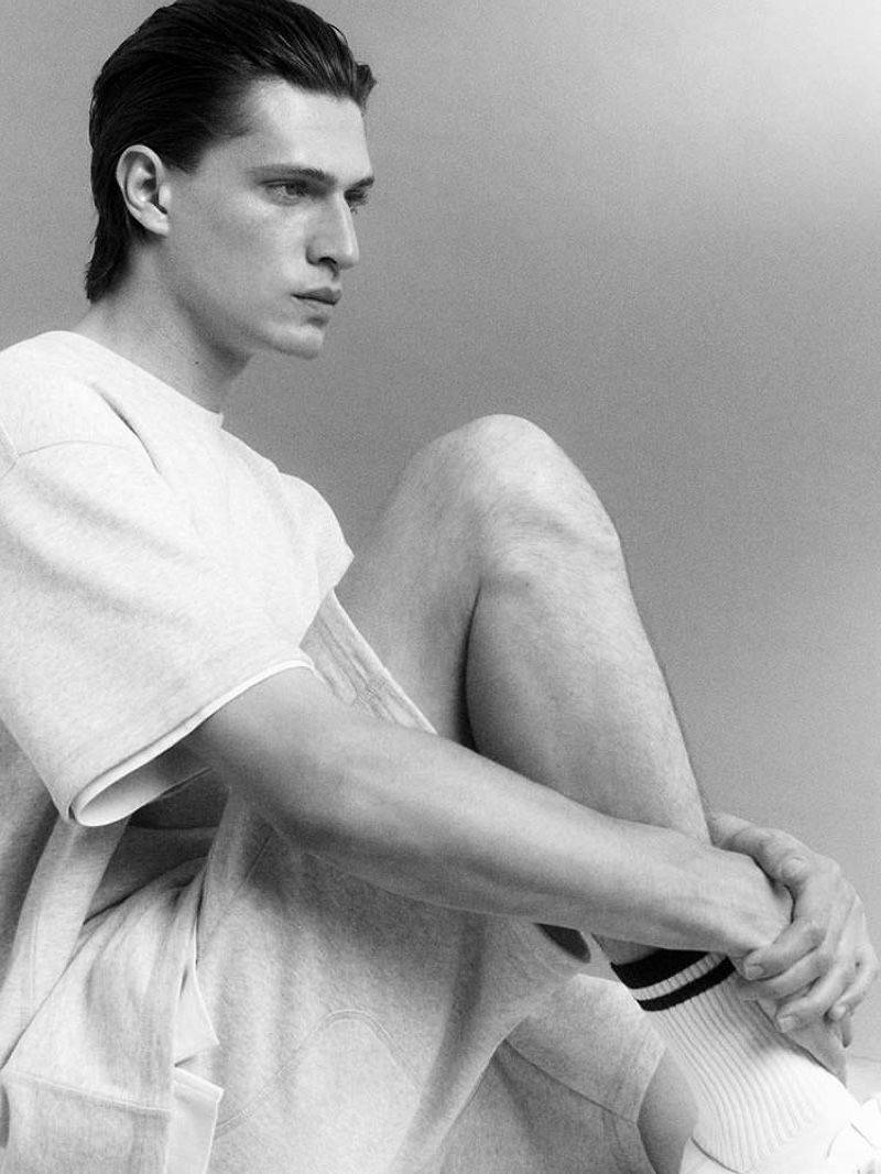   Edoardo Sebastianelli by Robin Galiegue for COS Men's Leisurewear Fall 2021 Ad Campaign. Clothing: COS LIGHT GRAY RELAXED-FIT SWEAT SHORTS / COS LIGHT GRAY OVERSIZED-FIT SWEAT T-SHIRT / COS WHITE RELAXED-FIT T-SHIRT / COS WHITE LEATHER LACE-UP SNEAKERS