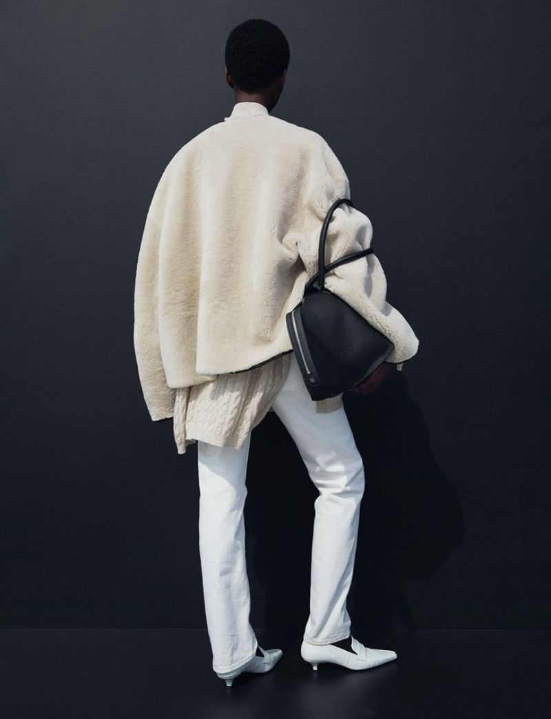  Clothing: Coat by Toteme / Toteme White Oversized cable-knit cashmere sweater / Toteme White Original twisted-seam straight-leg jeans 