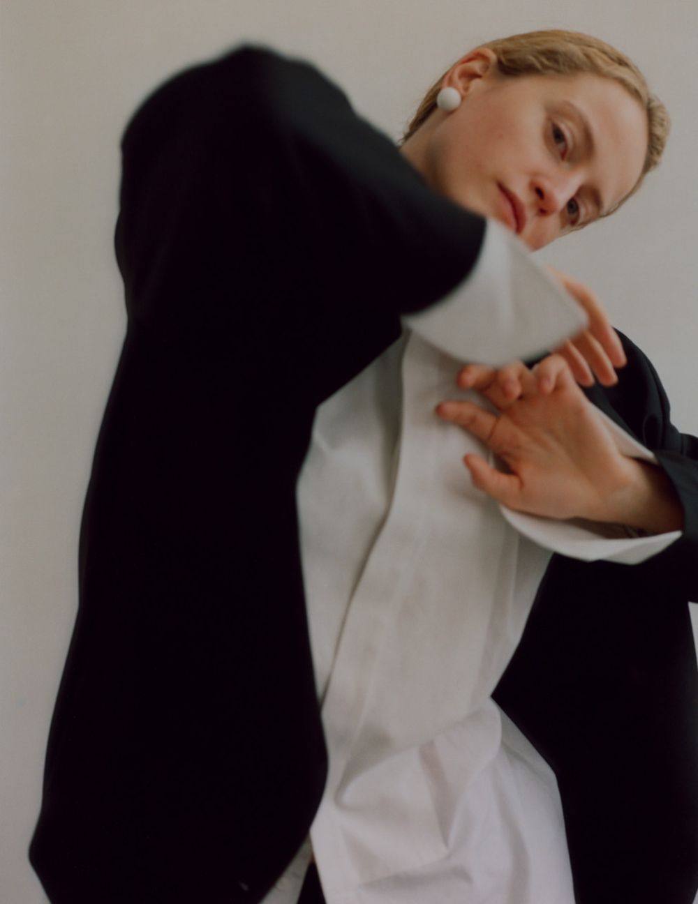  Clothing & Accessories: Wool Jacket and Pants by Chalayan; Cotton shirt by Turnbull & Asser; Cotton shorts by Miu Miu; Resin earrings by Christopher Kane / Photographer: Lukasz Pukowiec. Stylist: Adonis Kentros. Hair Stylist: Gor Duryan. Makeup Artist: Anna Stykala. Set Designer: Anna Szczesny 