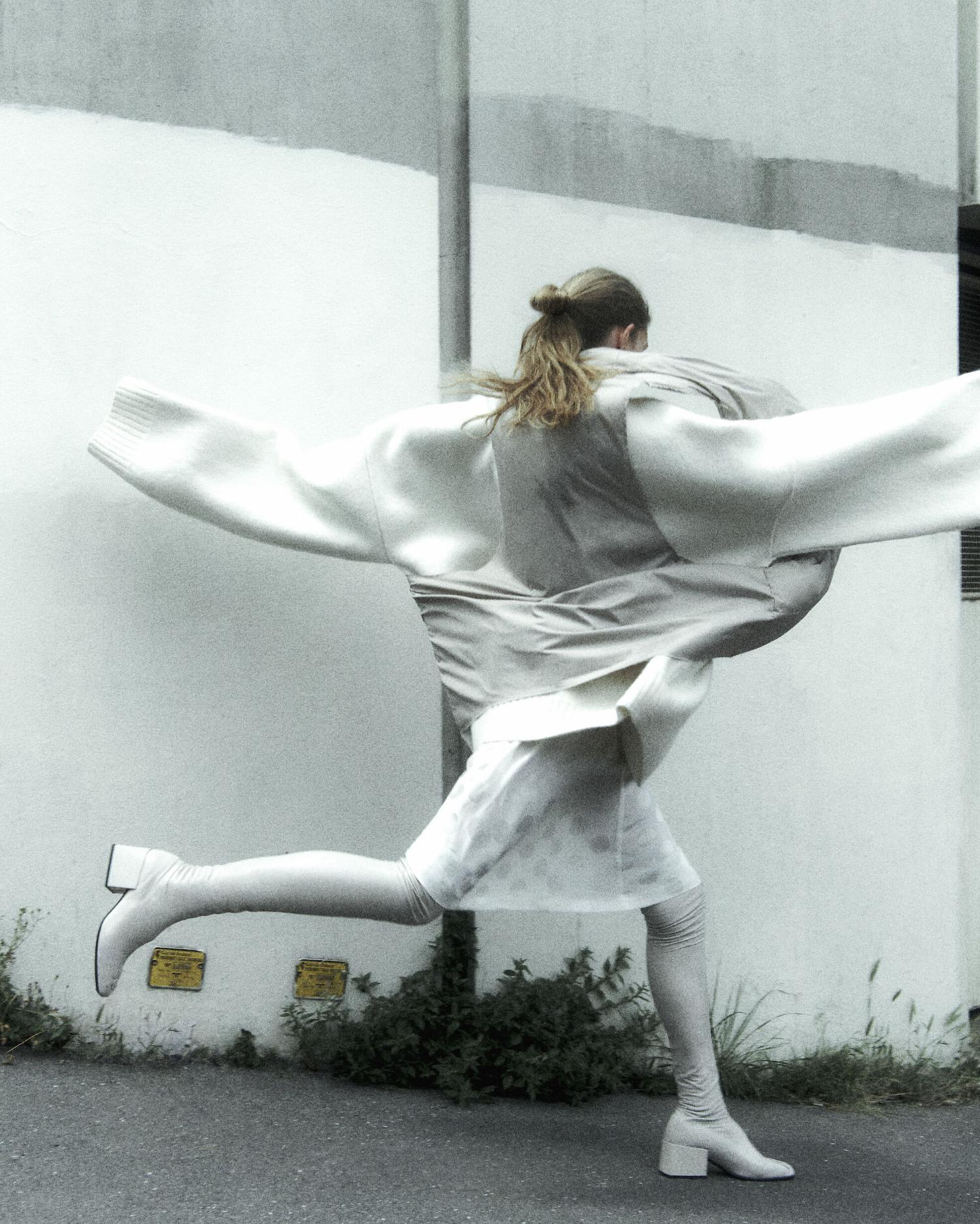 Ida Heiner by Robin Galiegue for Self Service Magazine Fall-Winter 2021 Beige nylon padded jacket, Cream mixed wool knit sweater, White silk dress by Raf Simons, Off-white leather thigh-high boots Courreges ⁠