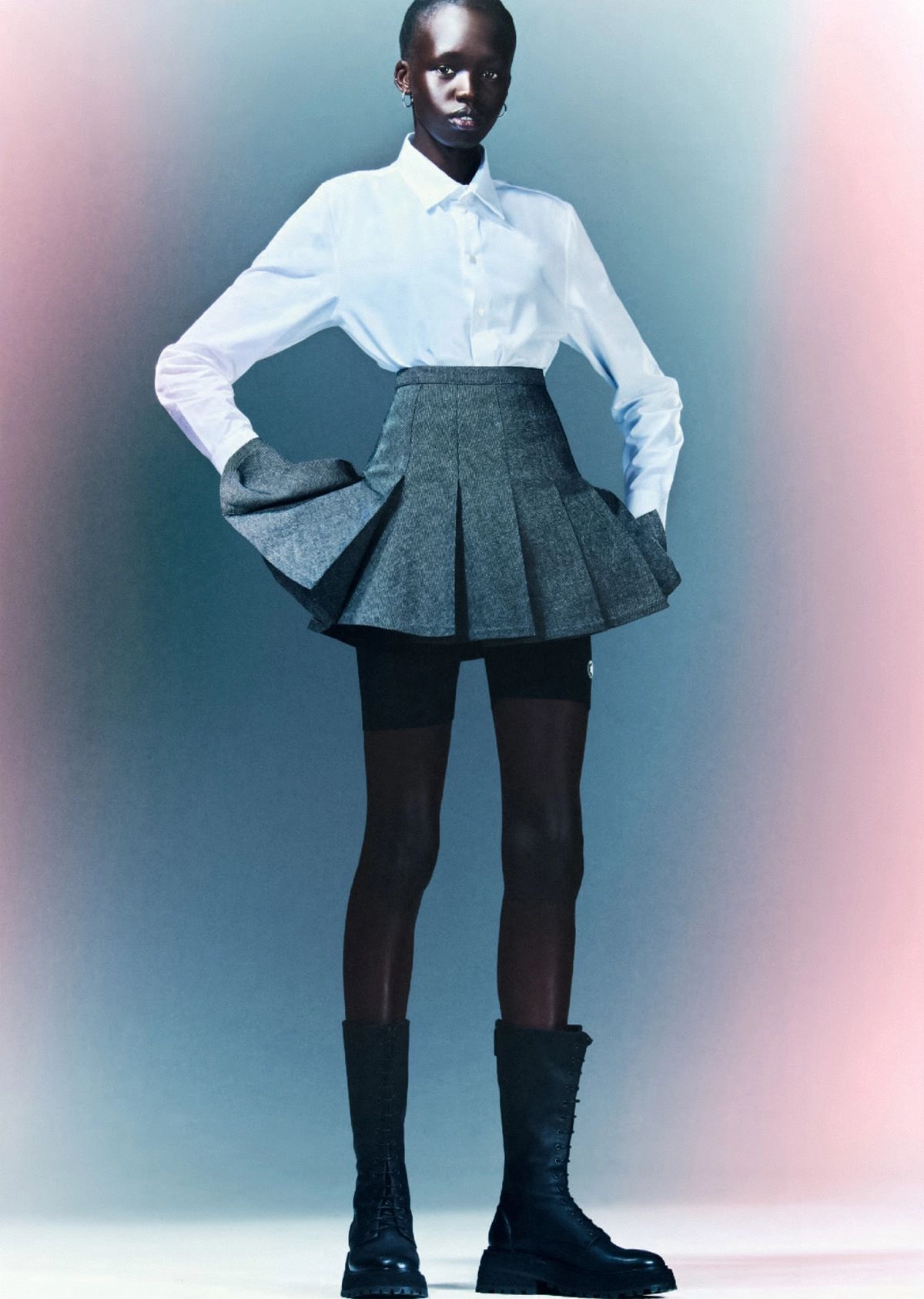 Clothing & Accessories: Cotton Shirt, Wool Skort and Technical Mesh Shorts, all by Dior / Black Carro Boots by Marsell / Gold and Diamond Earrings by Maria Tash / Silver Hoop Earrings by Slim Barrett