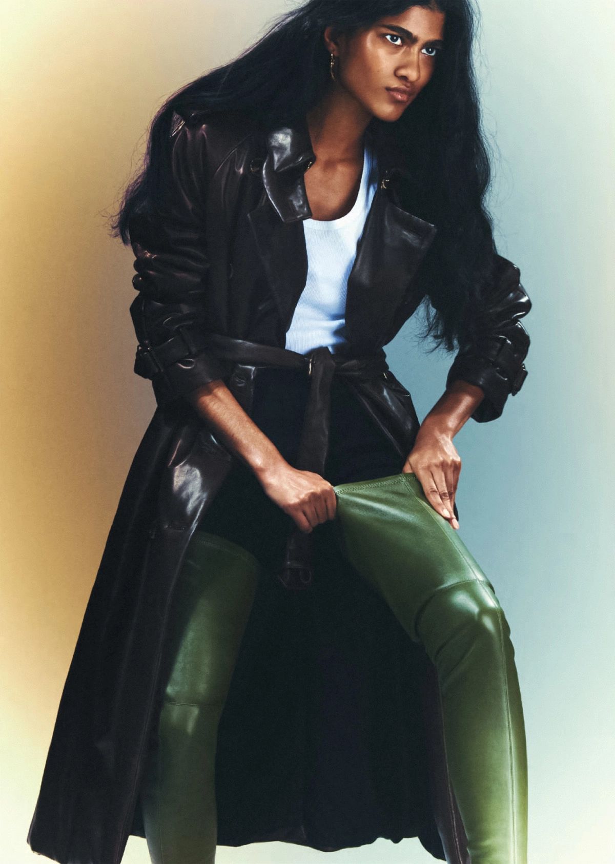 Ashley Radjarame by Thue Norgaard for British Vogue July 2022  Leather Trench Coat by Burberry / Stretch-Leather Boots by Burberry / White Organic Cotton Tank Top by Sunspel / Black Seamless Sculpt Sculpting Mid-Thigh Shorts by SKIMS 