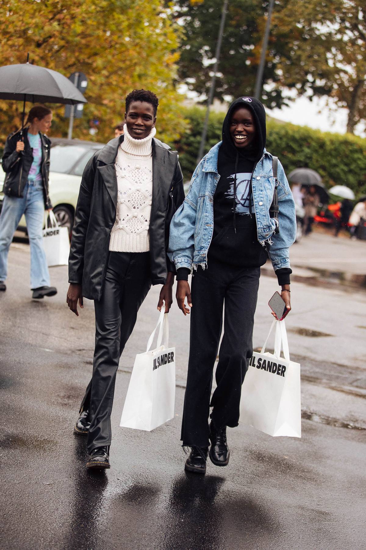 Ajah Angau Jok in Dr. Martens Black 1460 Boots  and Anyier Anei Street Style at Milan Fashion Week Spring-Summer 2023