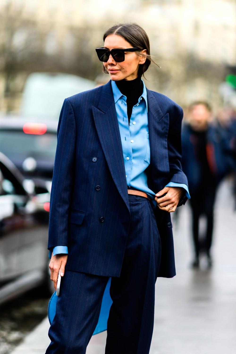 Julie Pelipas in Double-Breasted Navy Striped Pant Suit, Blue Shirt and Black Turtleneck