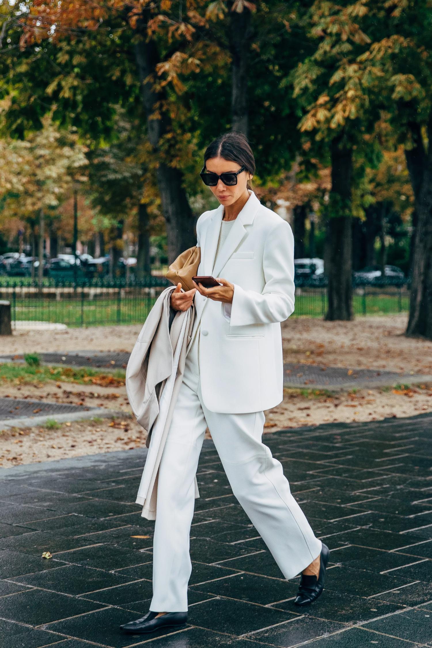Julie Pelipas wears White Tailored Suit and Trench Coat