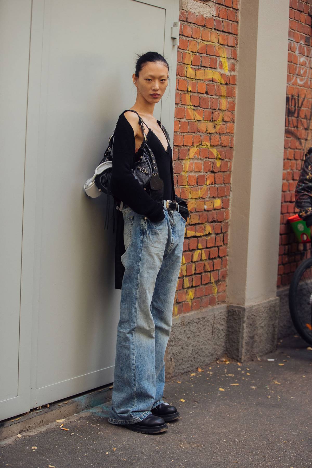 Sora Choi wears Balenciaga Black Small Le Cagole Shoulder Bag Outfit at Milan Fashion Week Spring-Summer 2023
