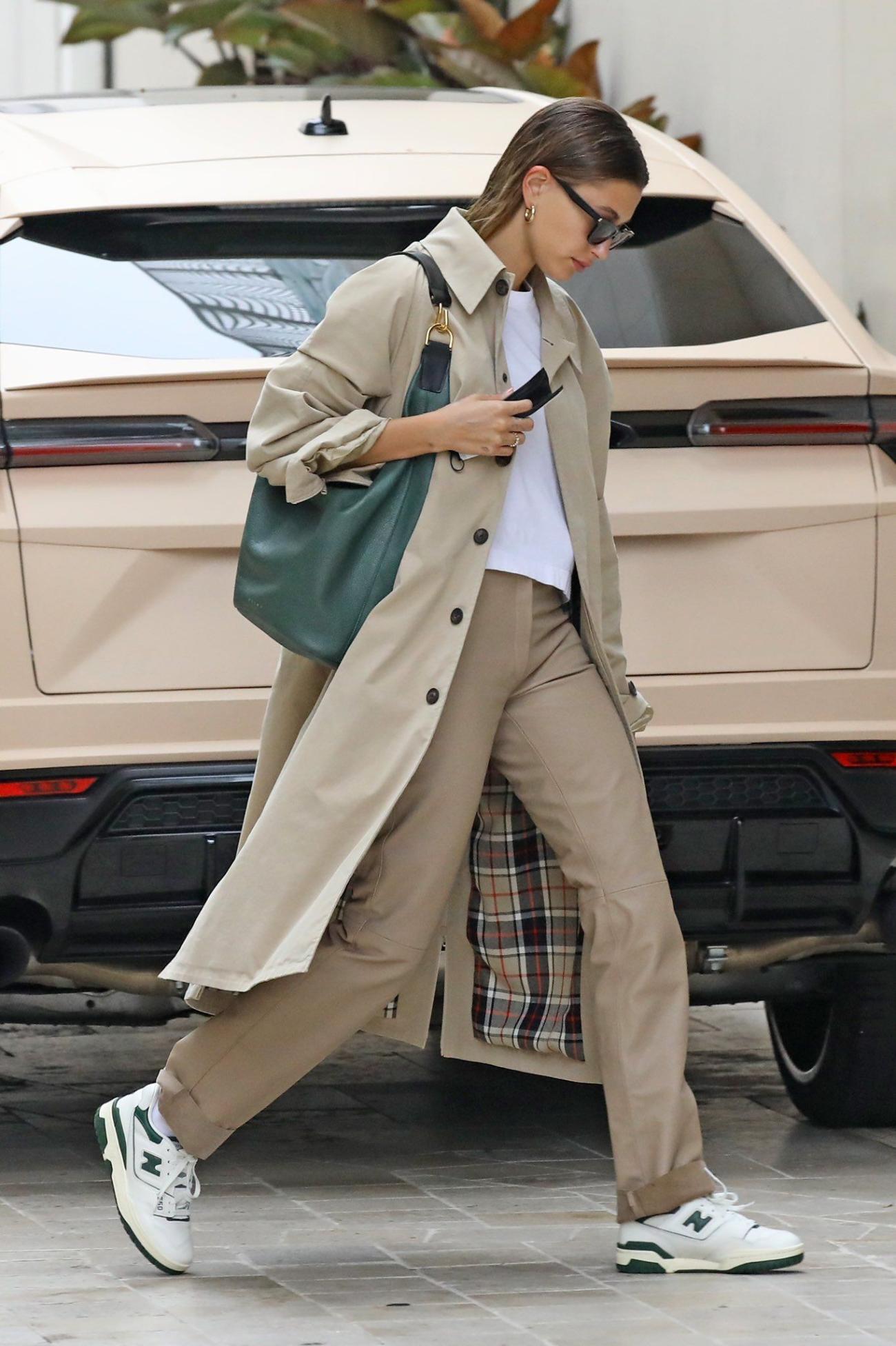 Celebrity Style Neutral Beige Trench Coat & Trousers, Basic White T-Shirt, New Balance 550 White & Team Forest Green Sneakers Outfit