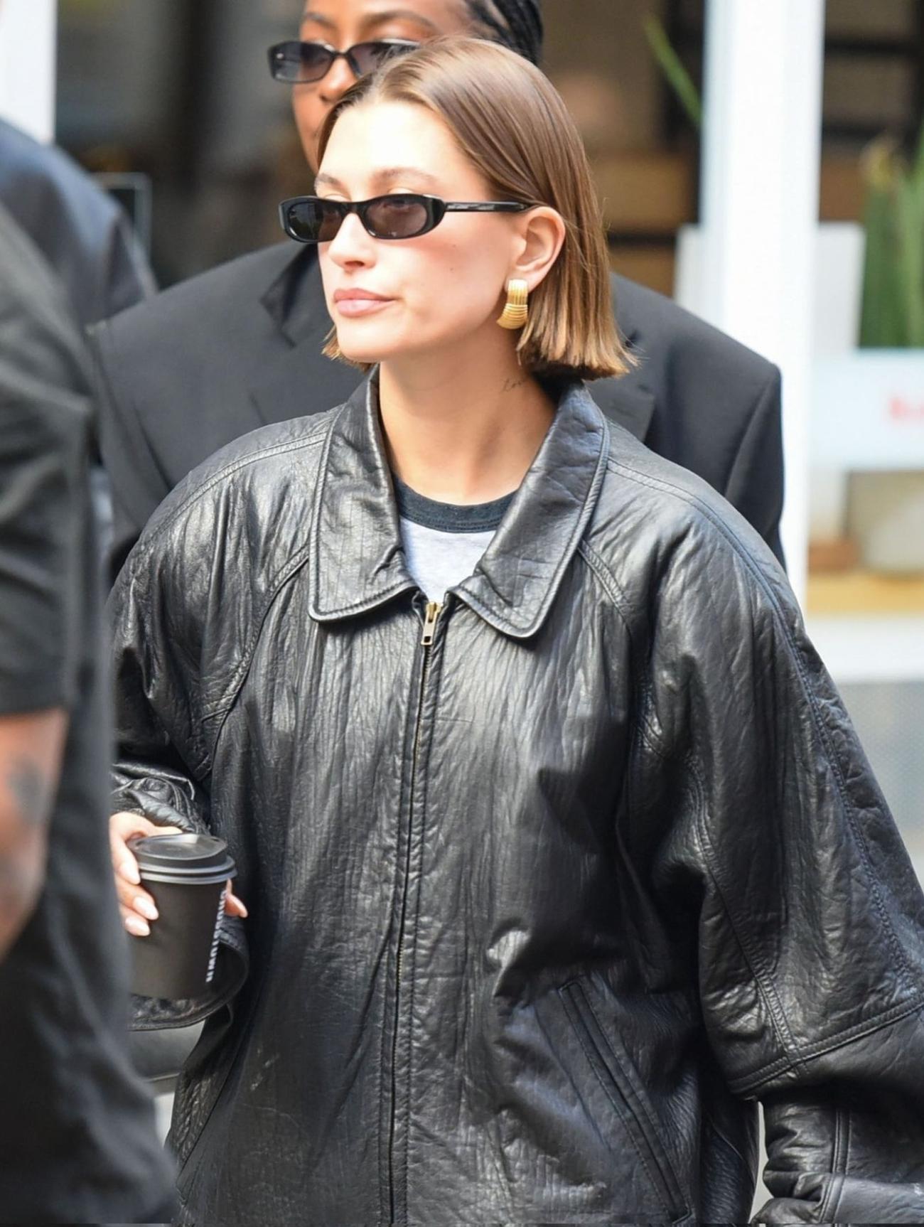 Hailey Bieber in London wearing Previously Known Vintage Black Oversized Zip-Up Jacket, Saint Laurent Black SL 557 Shade Sunglasses