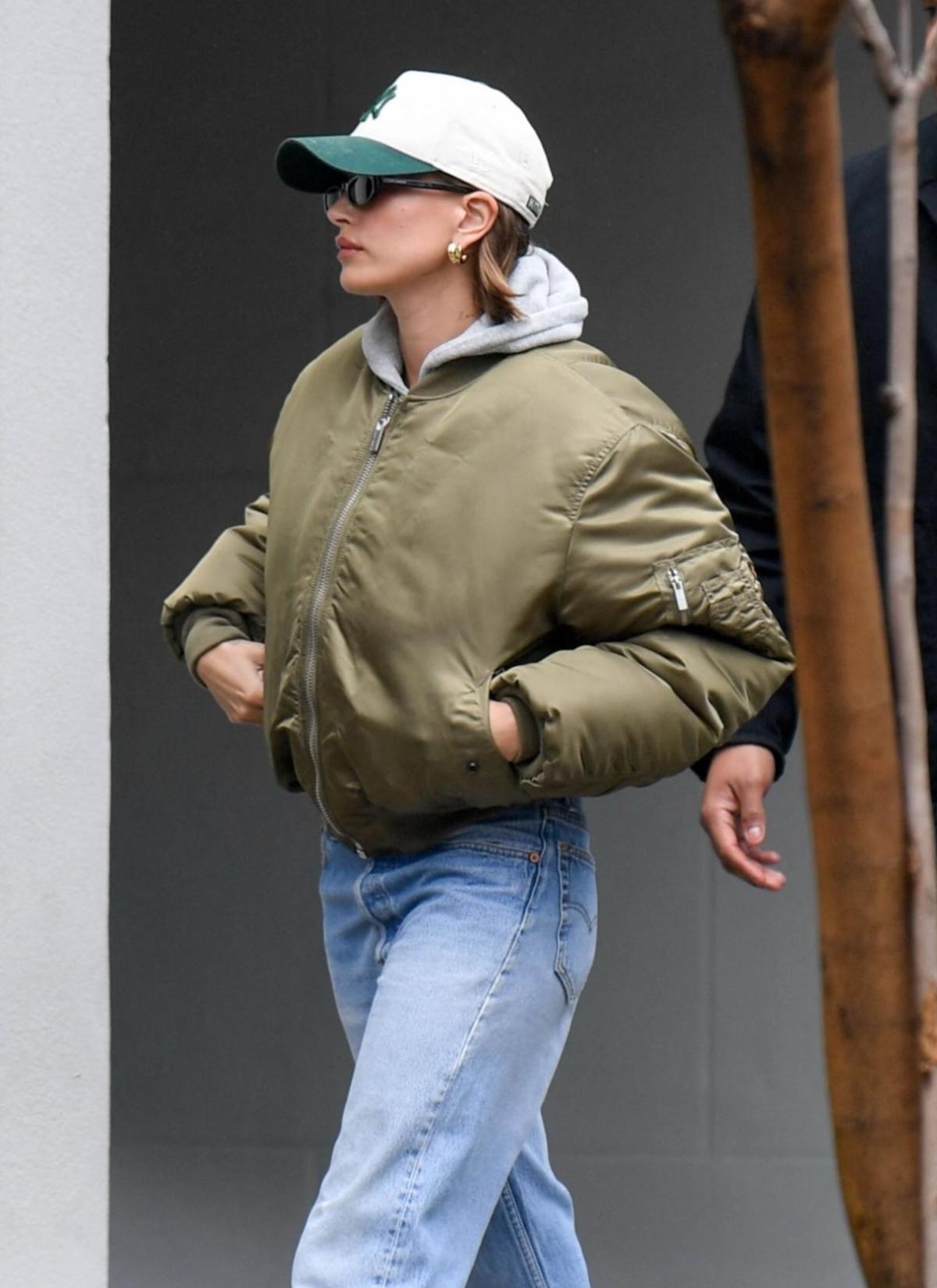 Celebrity Style VTMNTS Khaki & Beige Alpha Industries Edition Reversible Bomber Jacket, Saint Laurent Black SL 557 Shade Sunglasses, Levi's Blue Baggy 501 '90s Jeans, Hoodie and Cap Outfit in Beverly Hills, California