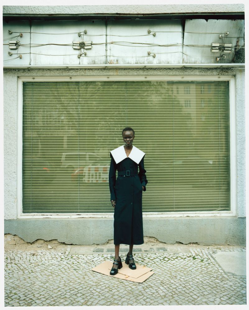 Adau Aguer in Jil Sander Black Double Breasted Wool Blend Coat with White Oversized Collar by Nina Raasch for CAP 74024 Magazine June 2023