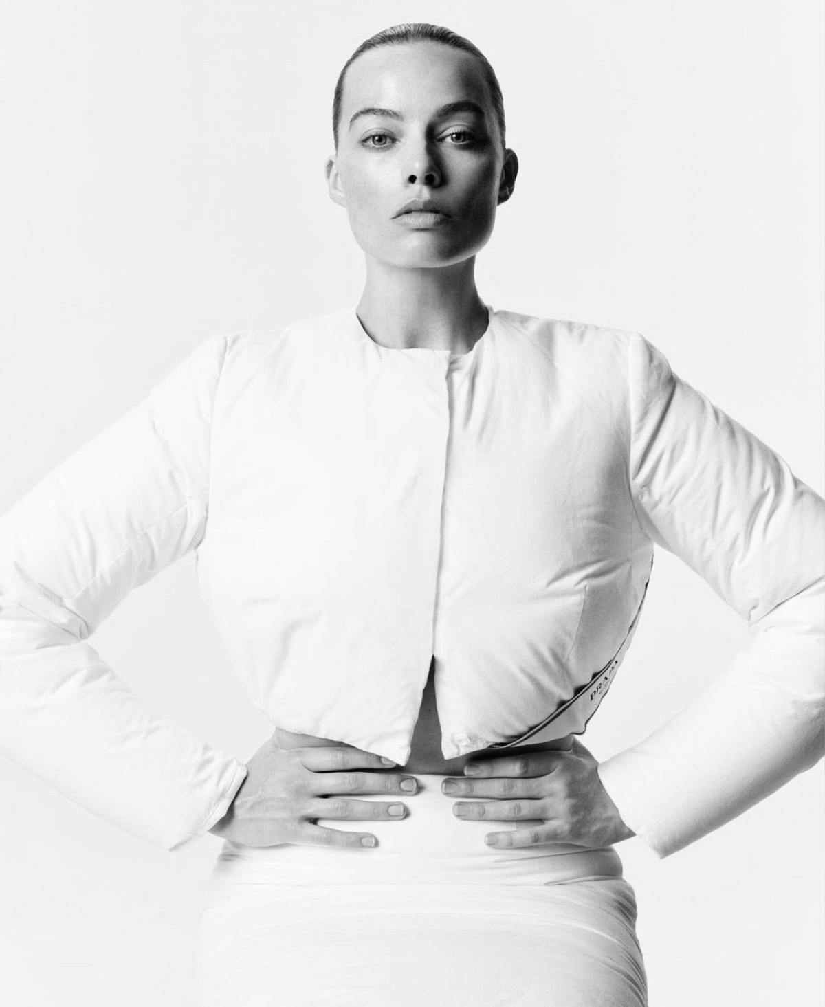 Margot Robbie wears Prada White Cropped Padded Jacket and Prada White Padded Pencil Skirt