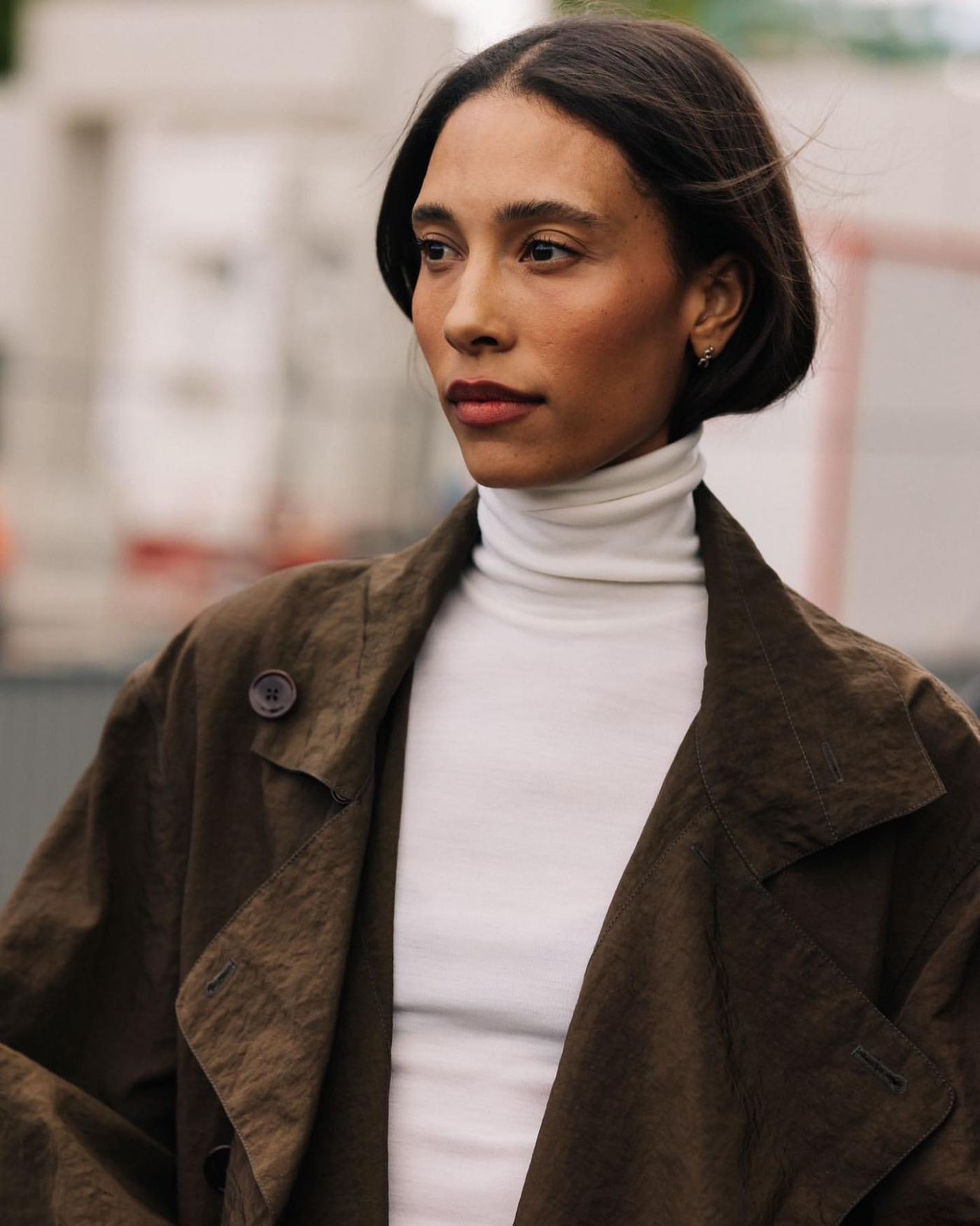 TyLynn Nguyen wears Lemaire Brown Trench Coat, REFINE White Turtleneck in Paris Refined Minimal Fashion