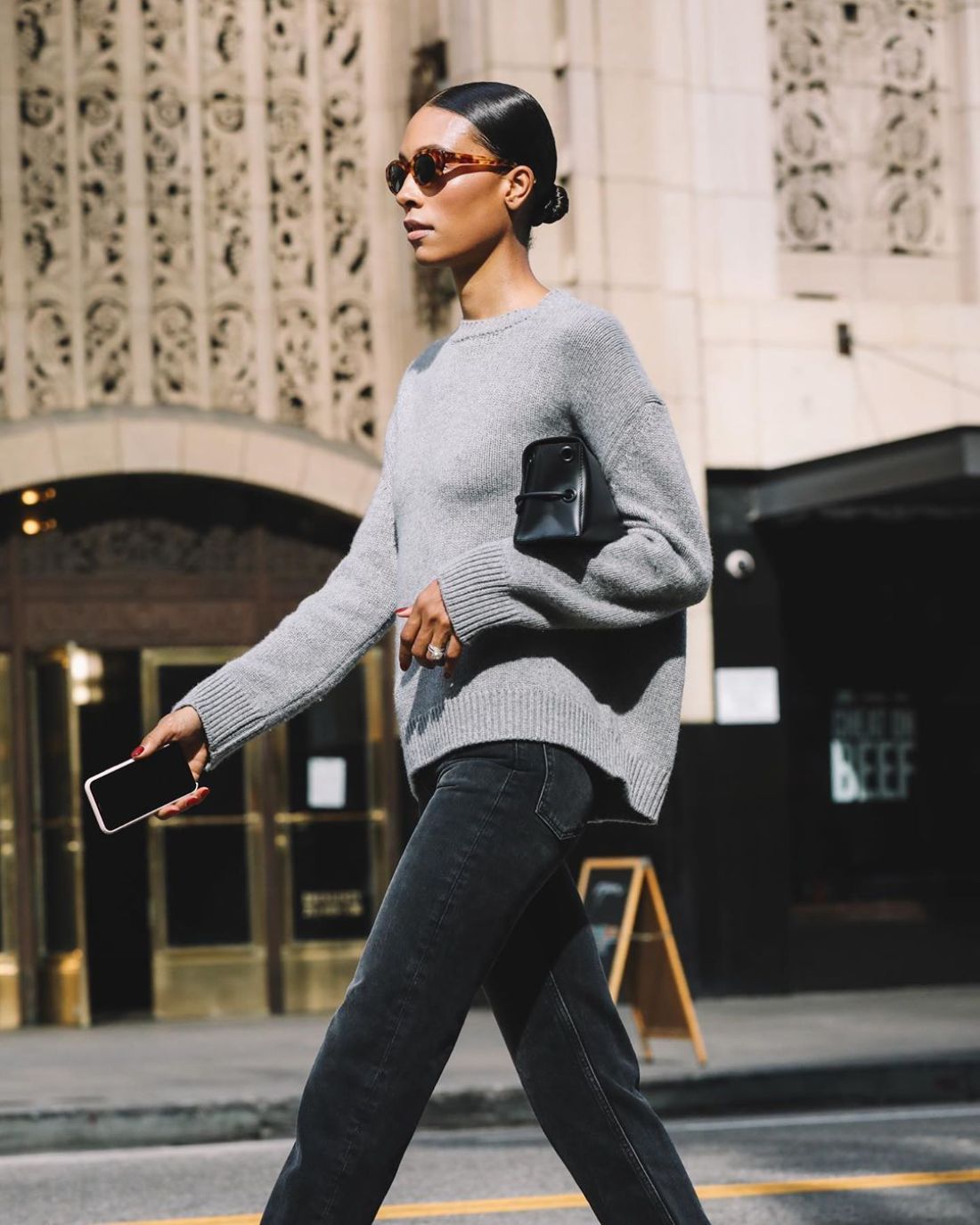 Tylynn Nguyen wears Casual Weekend Outfit, Anine Bing Grey Sweater, Black Jeans and Tortoiseshell Sunglasses