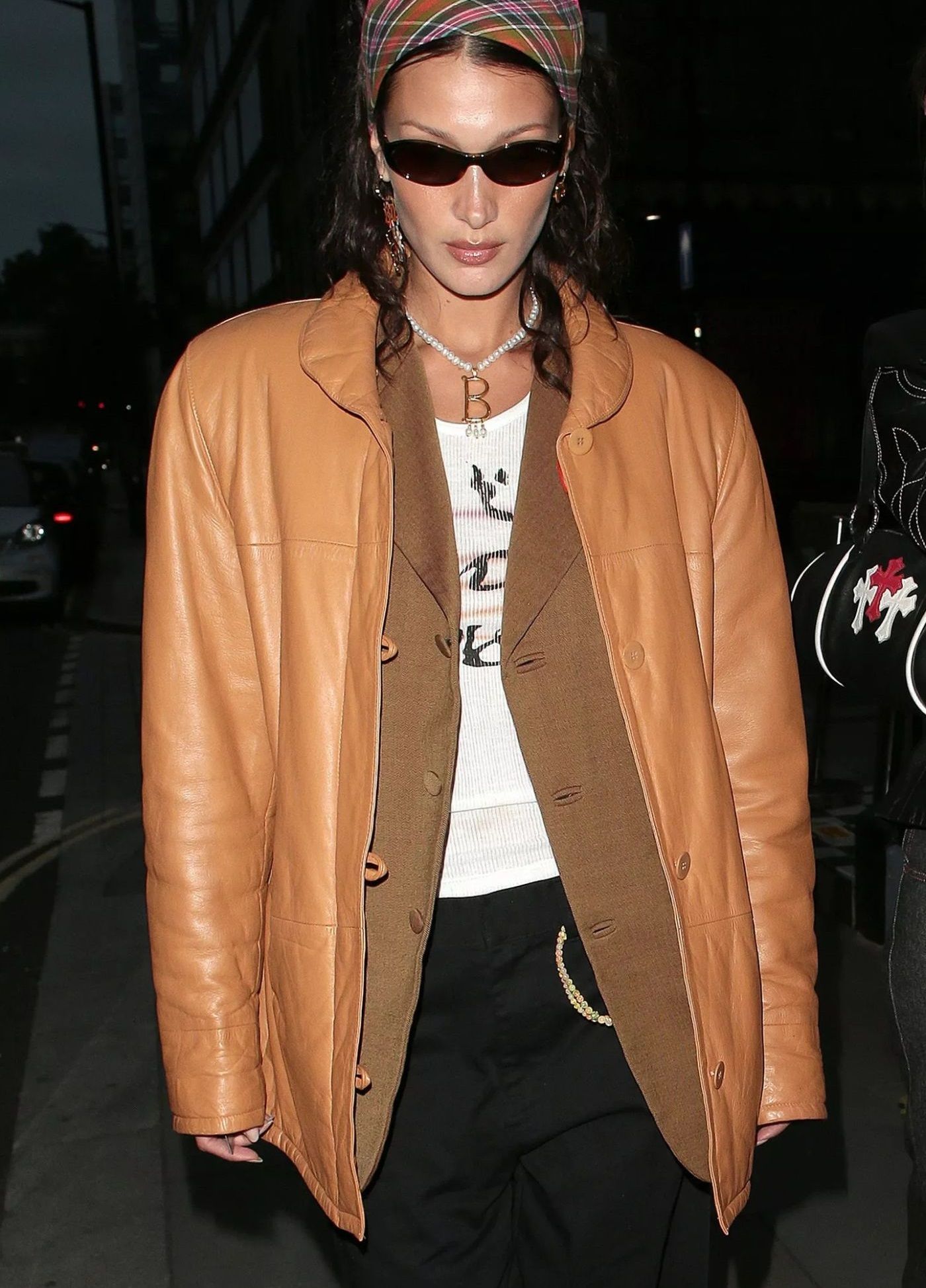 Bella Hadid 90s Outfit Vintage Brown Leather Jacket, Lucky Jewel Airbrush Logo Tank, Eytys Black Roxy Trousers, Vogue Eyewear Vo5315S Sunglasses