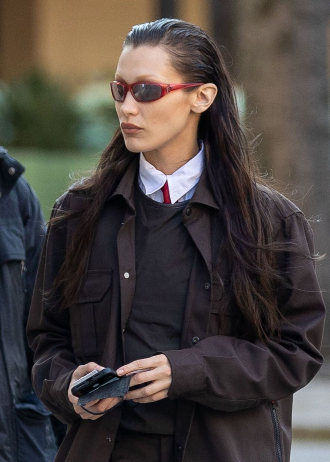 Bella Hadid in Paris wearing Brown Jacket, White Shirt with Red Tie, Sports Sunglasses Y2K Outfit