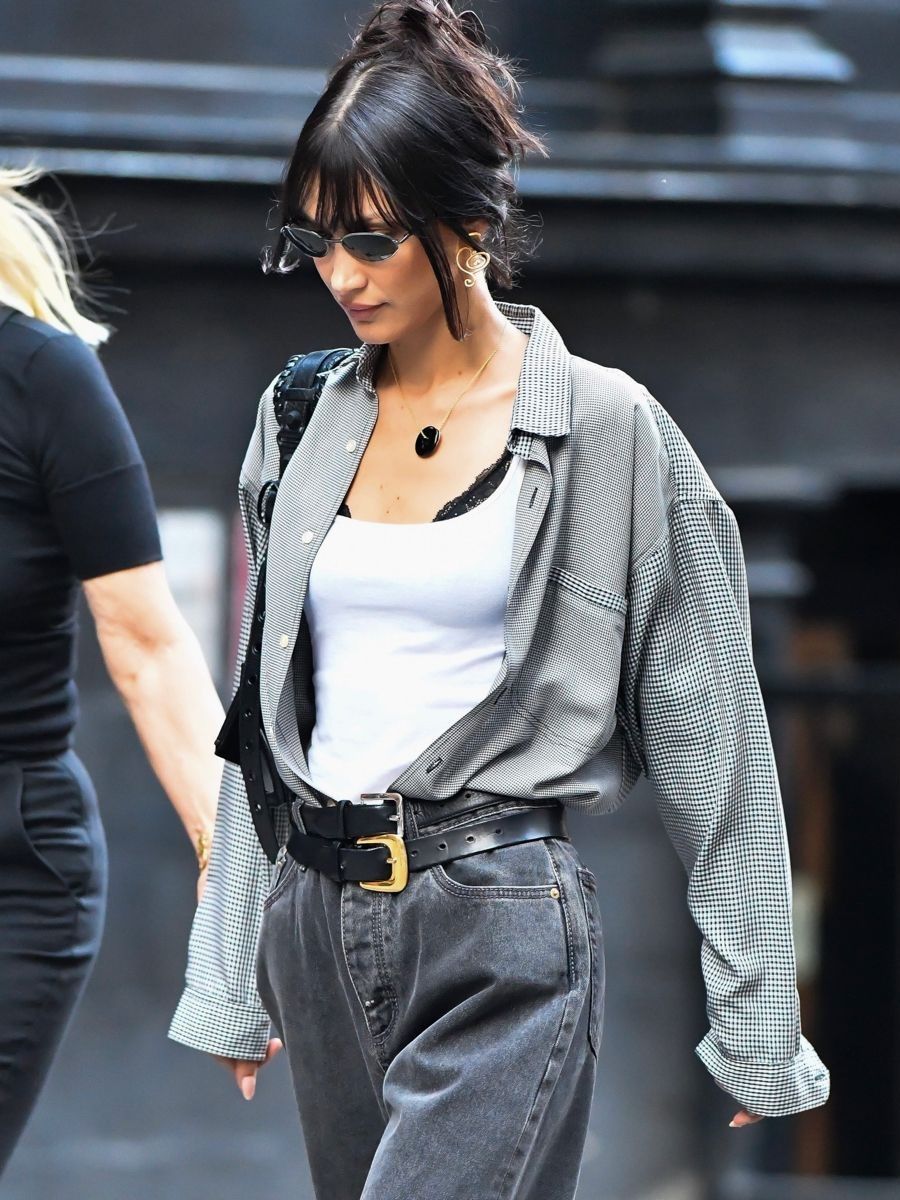 Bella Hadid in New York wearing Grey Jeans and Shirt, White Tank Top, Balenciaga Black XS Le Cagole Bag, Jean Paul Gaultier Vintage Oval Sunglasses Minimal Outfit