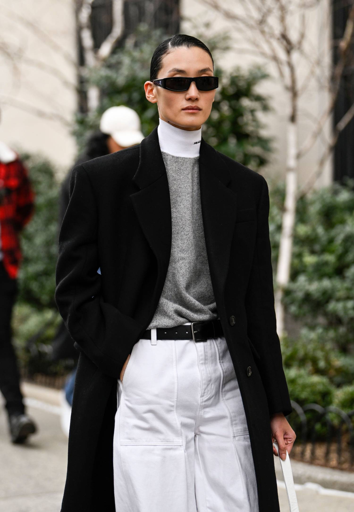 Lina Zhang wears Black Coat, Prada Turtleneck, White Jeans
