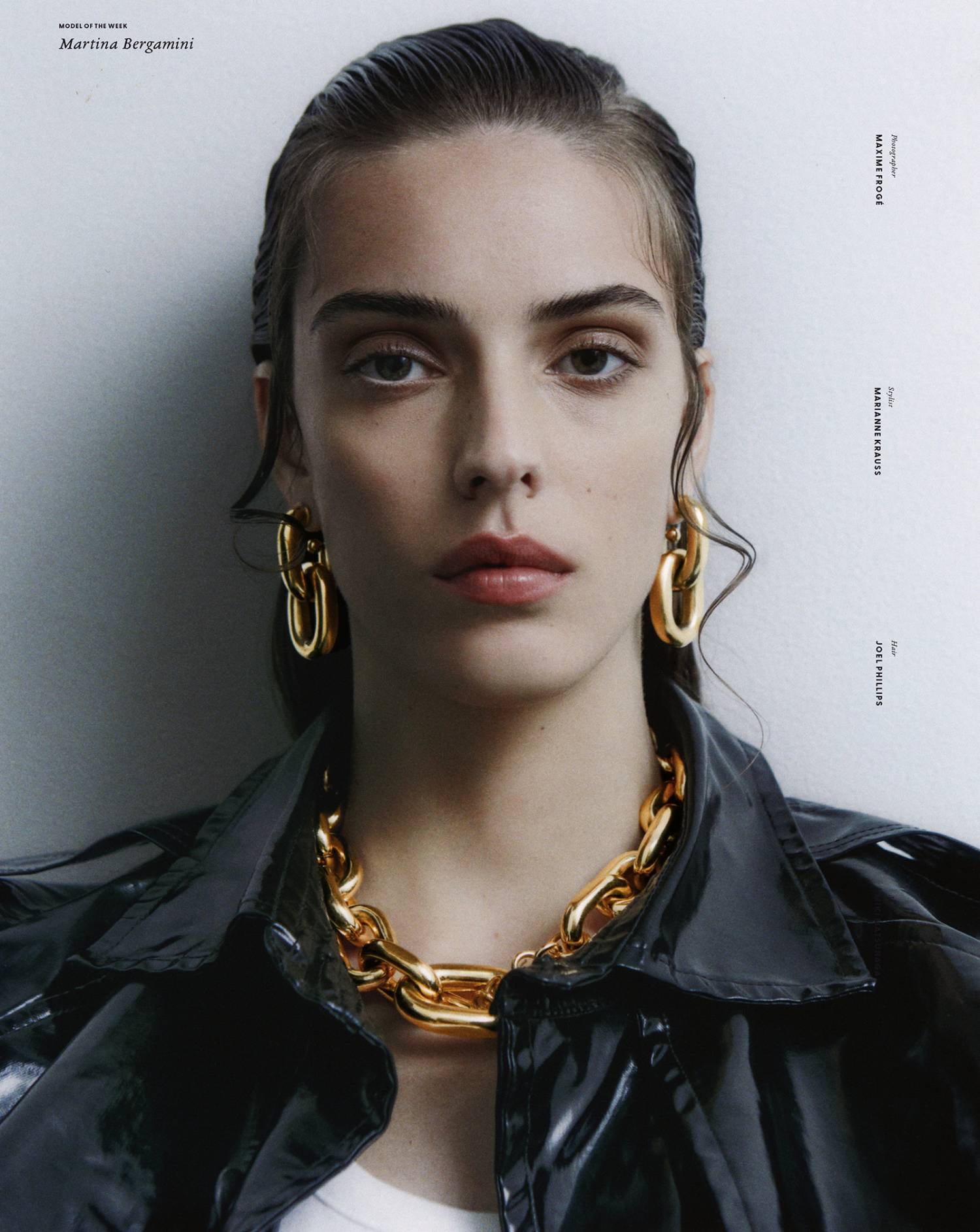 Martina Bergamini by Maxime Froge for Models com, wearing Saint Laurent Black Patent Leather Coat and Rabanne Gold-Plated Chain Necklace and Earrings